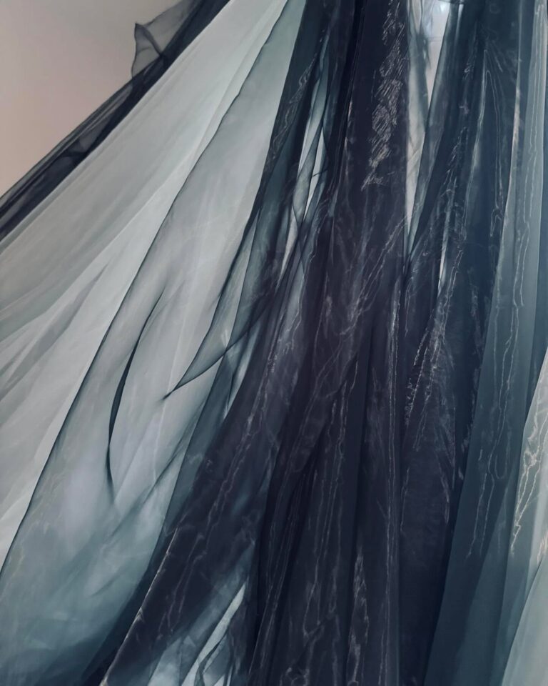 A gathered tulle skirt in graduated greys, the layers translucent where they overlap